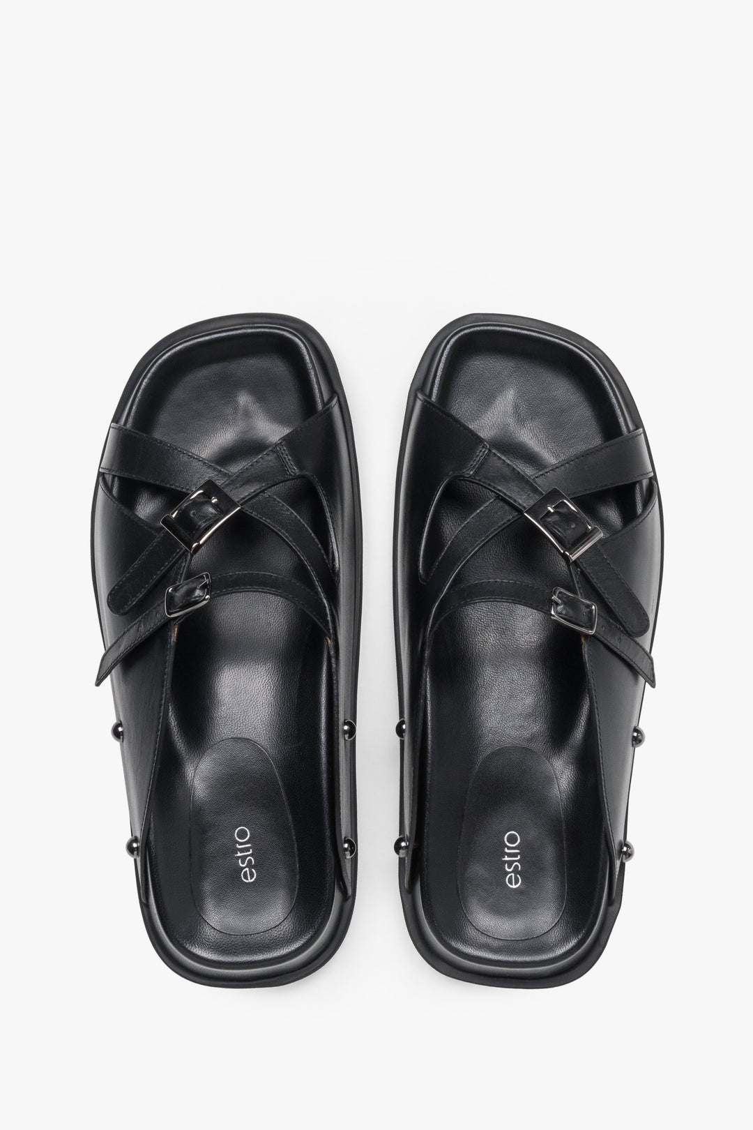 Top view of women's black leather slide sandals with silver buckles