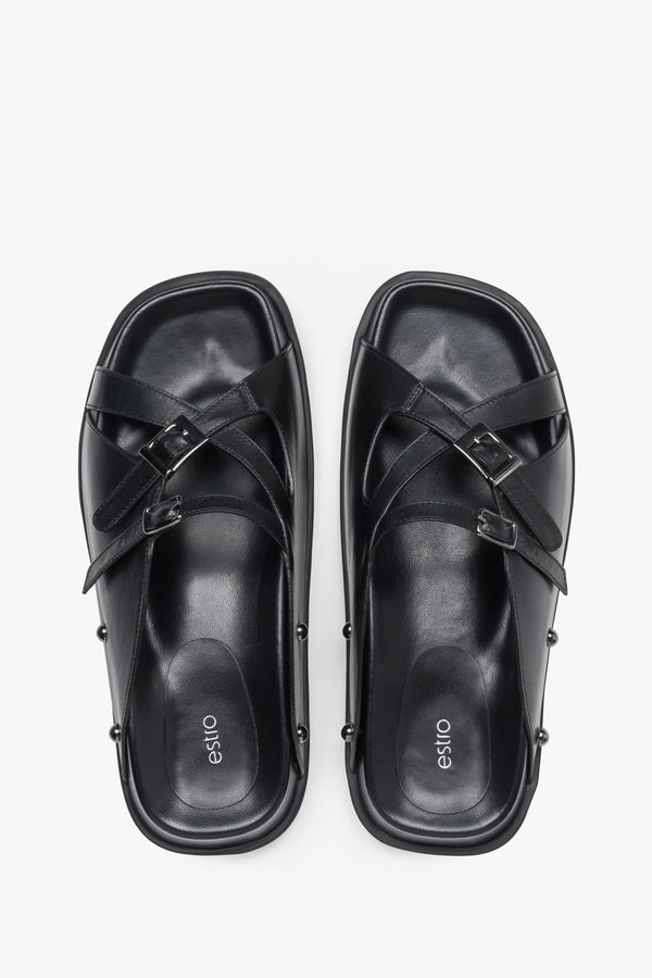 Top view of women's black leather slide sandals with silver buckles