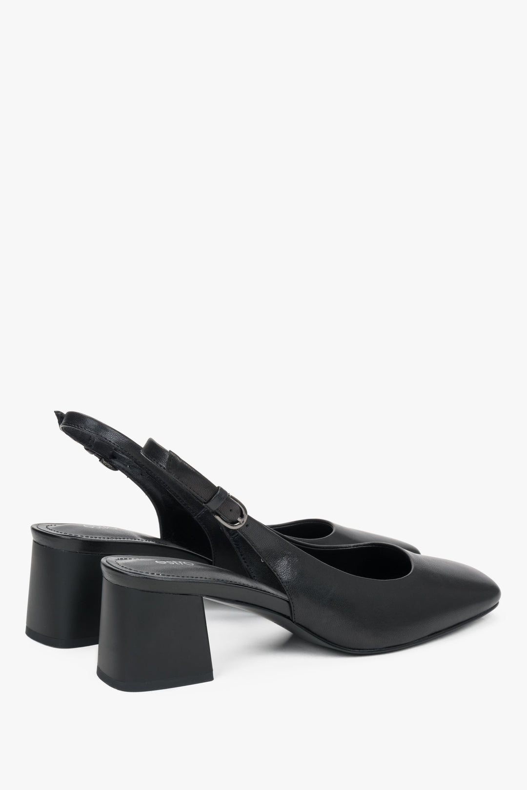 Close-up of the satin-finish black leather and silver buckle on block-heel pumps.