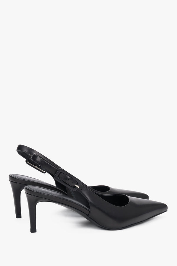 Close-up of the pointed toe and silver hardware on premium black leather pumps.