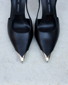 Profile of women's black leather slingback stilettos with a thin heel at the front