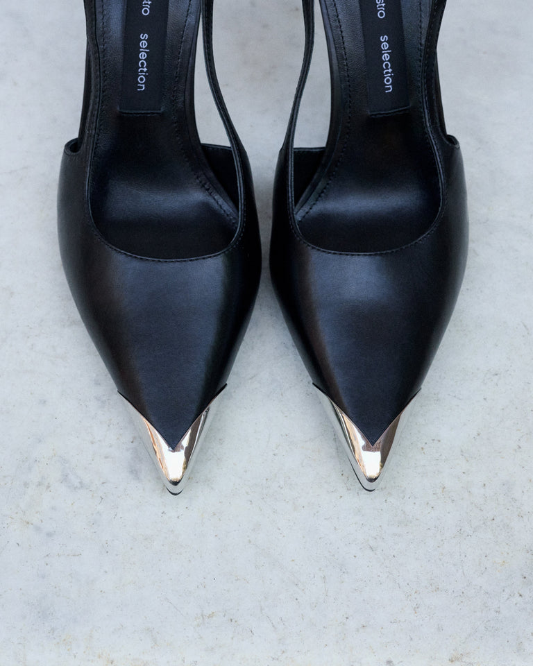 Profile of women's black leather slingback stilettos with a thin heel at the front