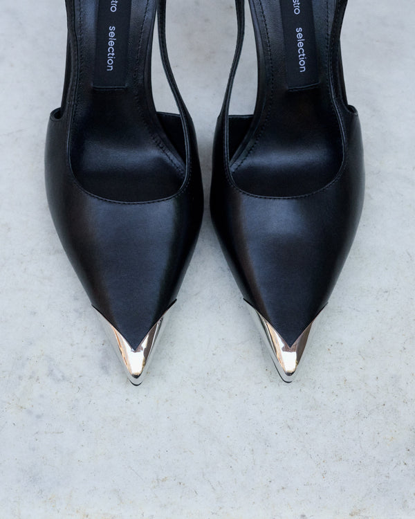 Profile of women's black leather slingback stilettos with a thin heel at the front