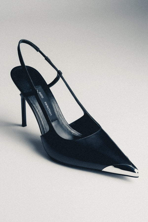 Detail view of silver pointed toe on black leather Estro Selection stilettos