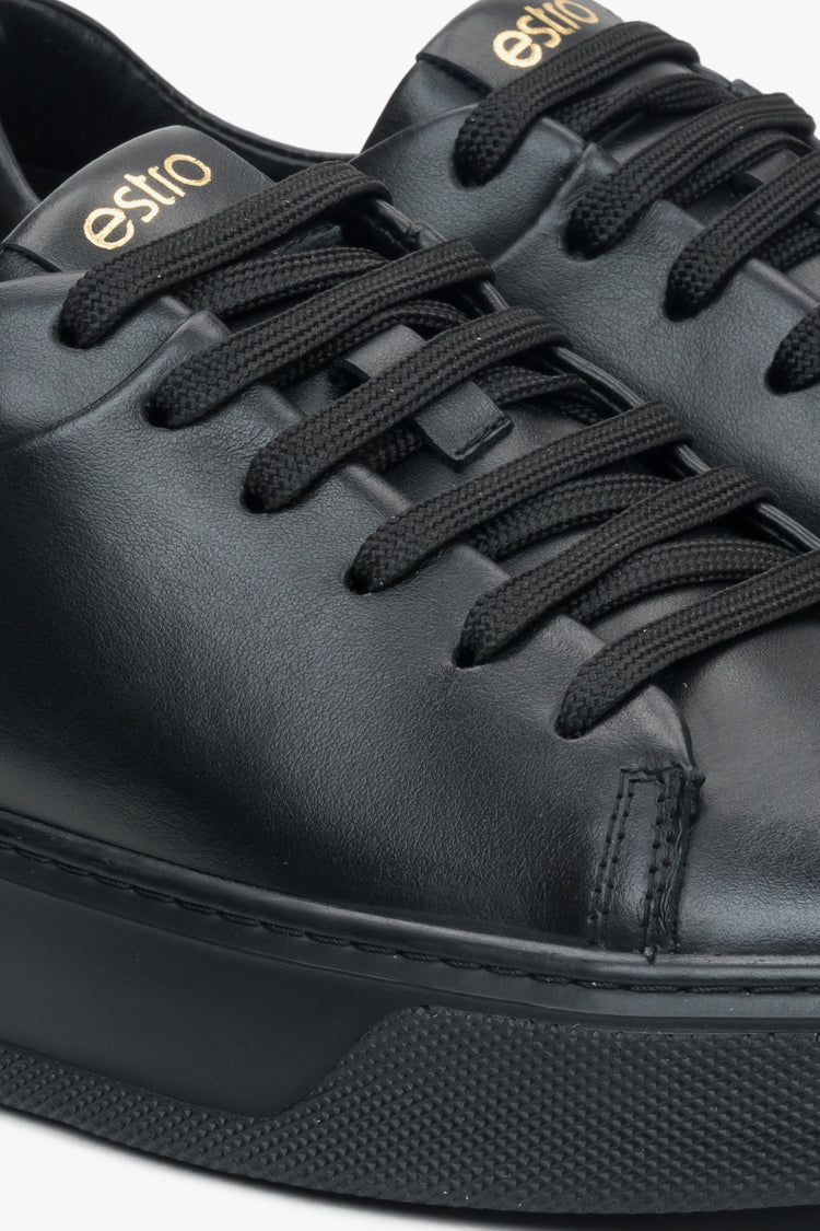 Close-up on details of black women's sneakers made of genuine leather Estro.
