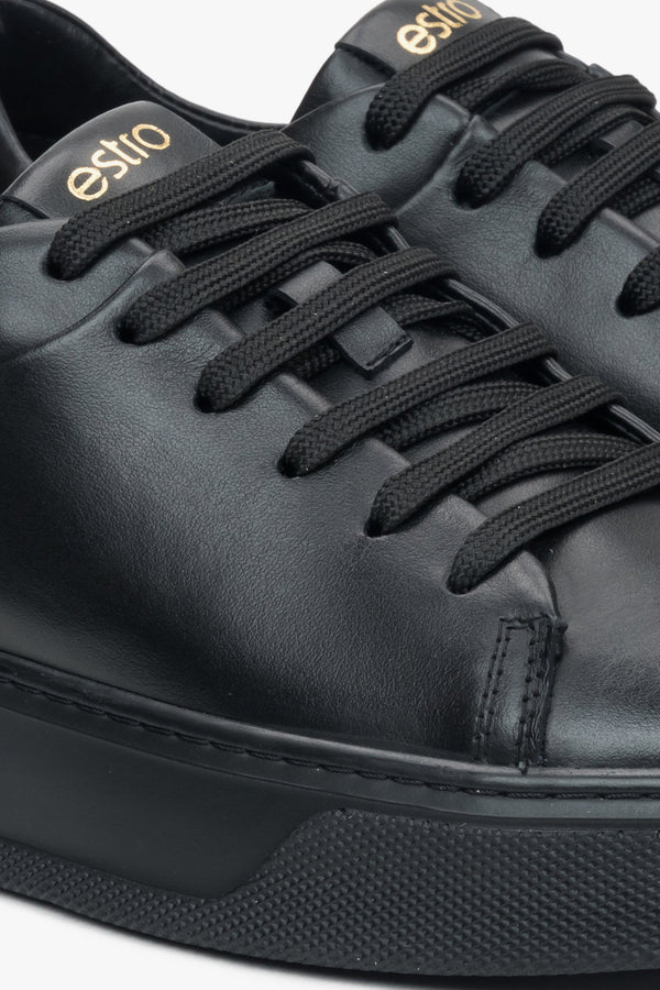 Close-up on details of black women's sneakers made of genuine leather Estro.