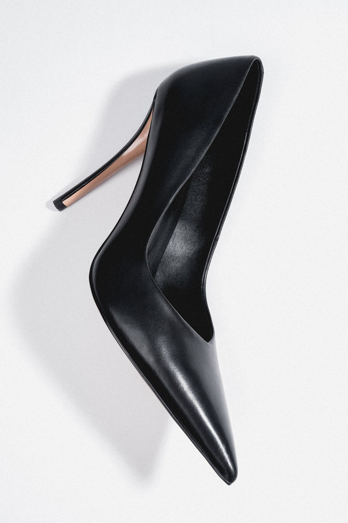 Women's black leather stiletto pumps with a slim heel and a pointed toe by Estro.