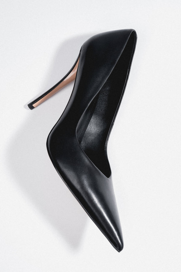 Women's black leather stiletto pumps with a slim heel and a pointed toe by Estro.