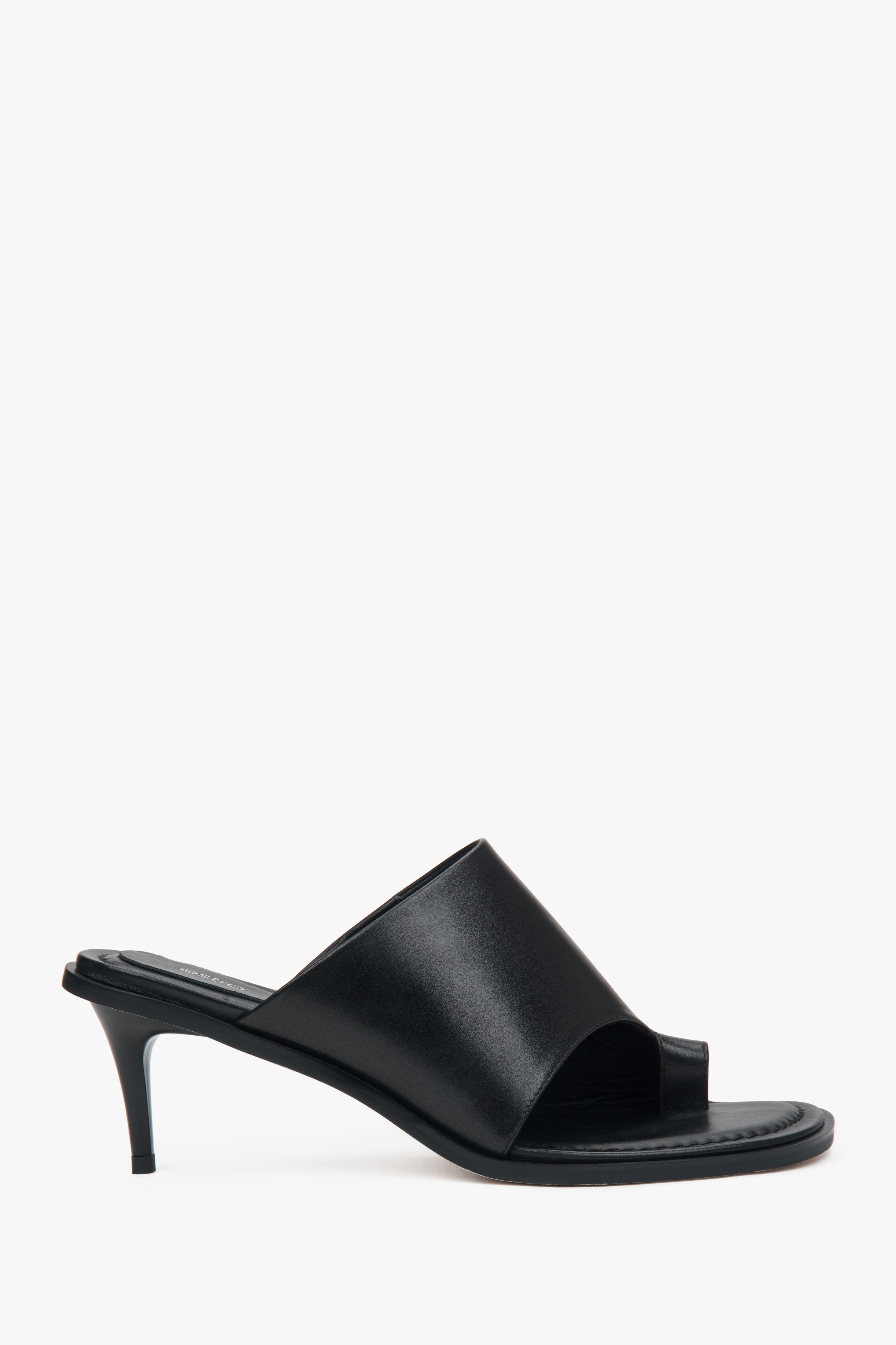 Black women’s leather stiletto mules with a toe ring.