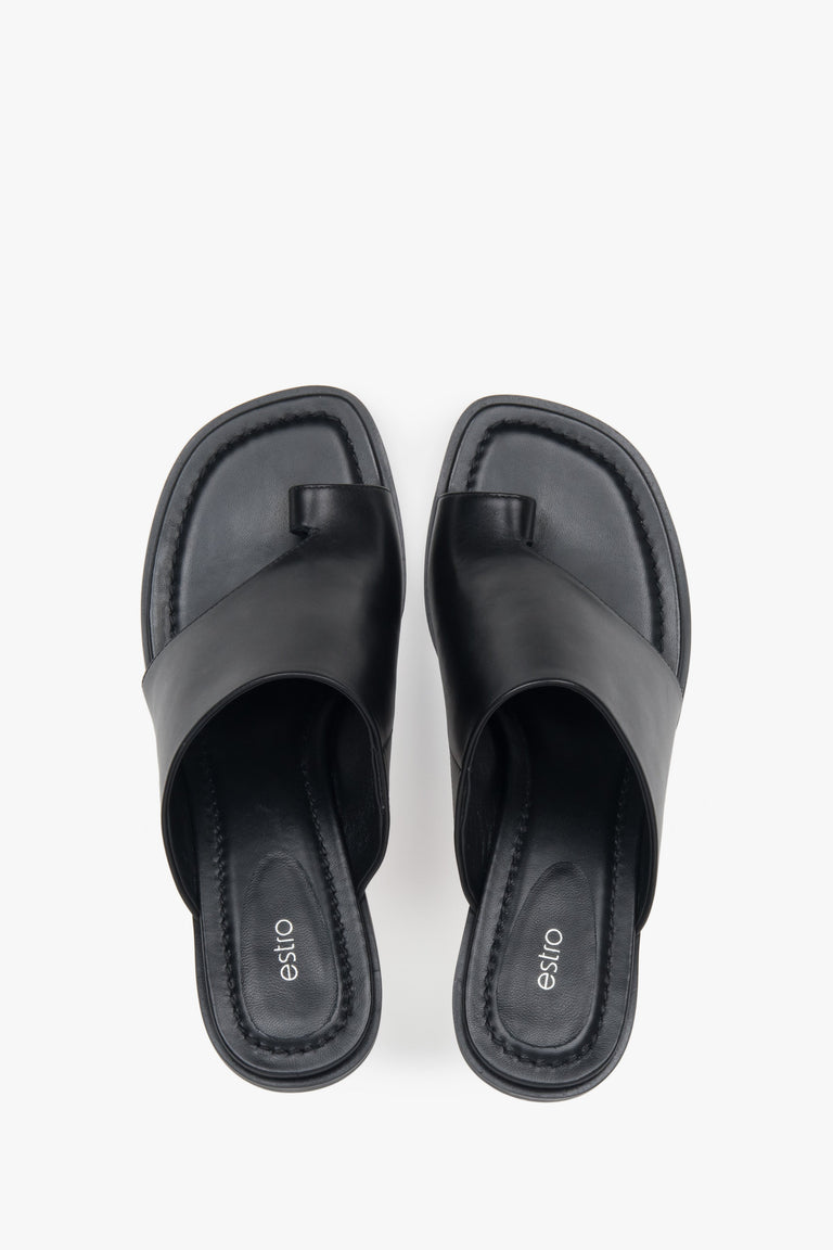 With a toe ring, black women’s leather stiletto mules by Estro.