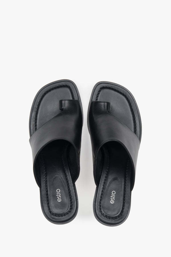 With a toe ring, black women’s leather stiletto mules by Estro.