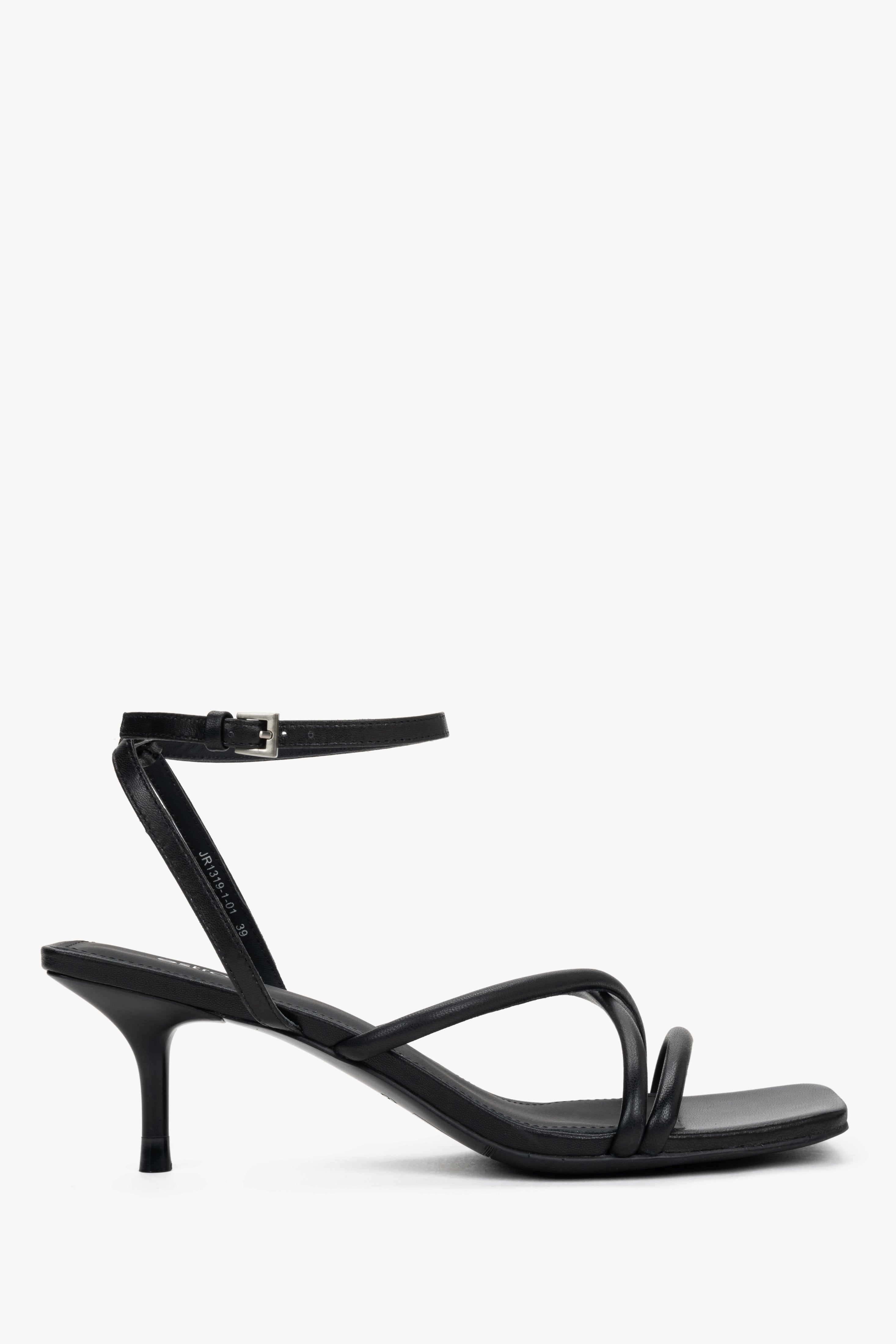 Women’s black leather stiletto sandals by Estro with thin crossing straps.