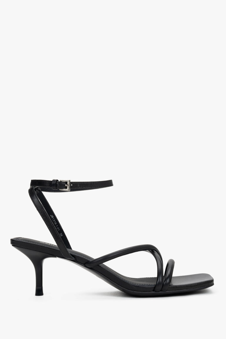Women’s black leather stiletto sandals by Estro with thin crossing straps.