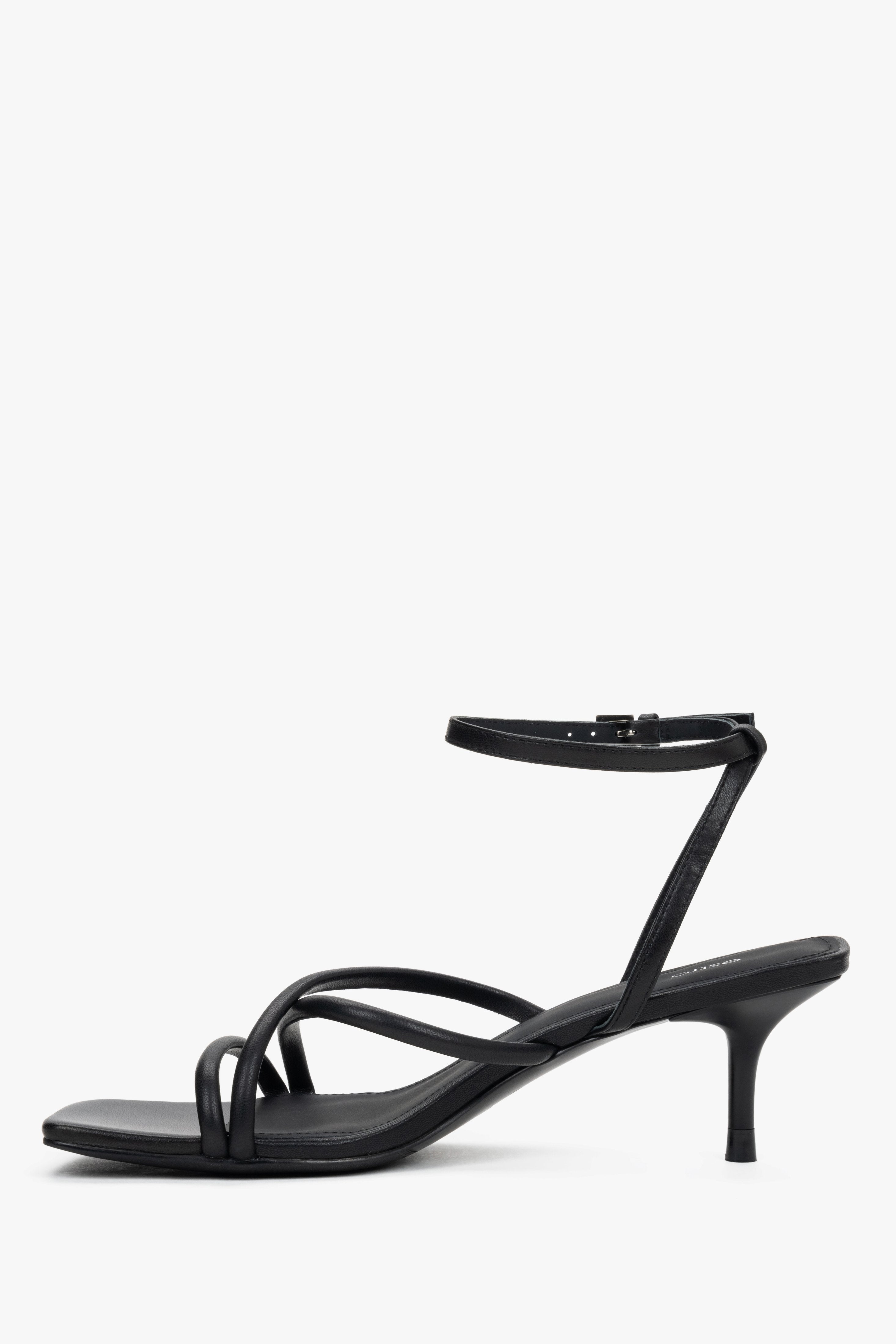 Women’s black leather sandals with 6.5 cm stiletto heel and buckle fastening.