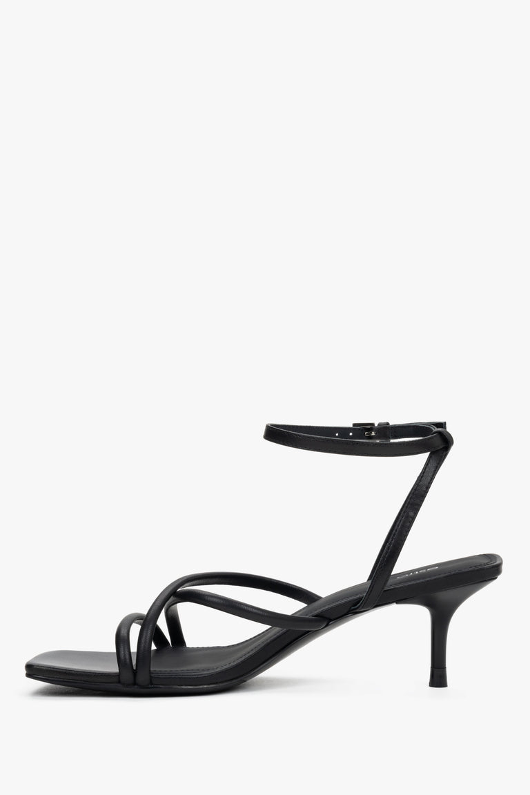 Women’s black leather sandals with 6.5 cm stiletto heel and buckle fastening.