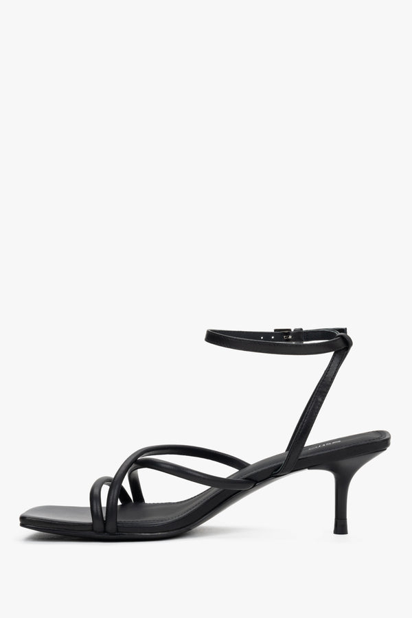 Women’s black leather sandals with 6.5 cm stiletto heel and buckle fastening.