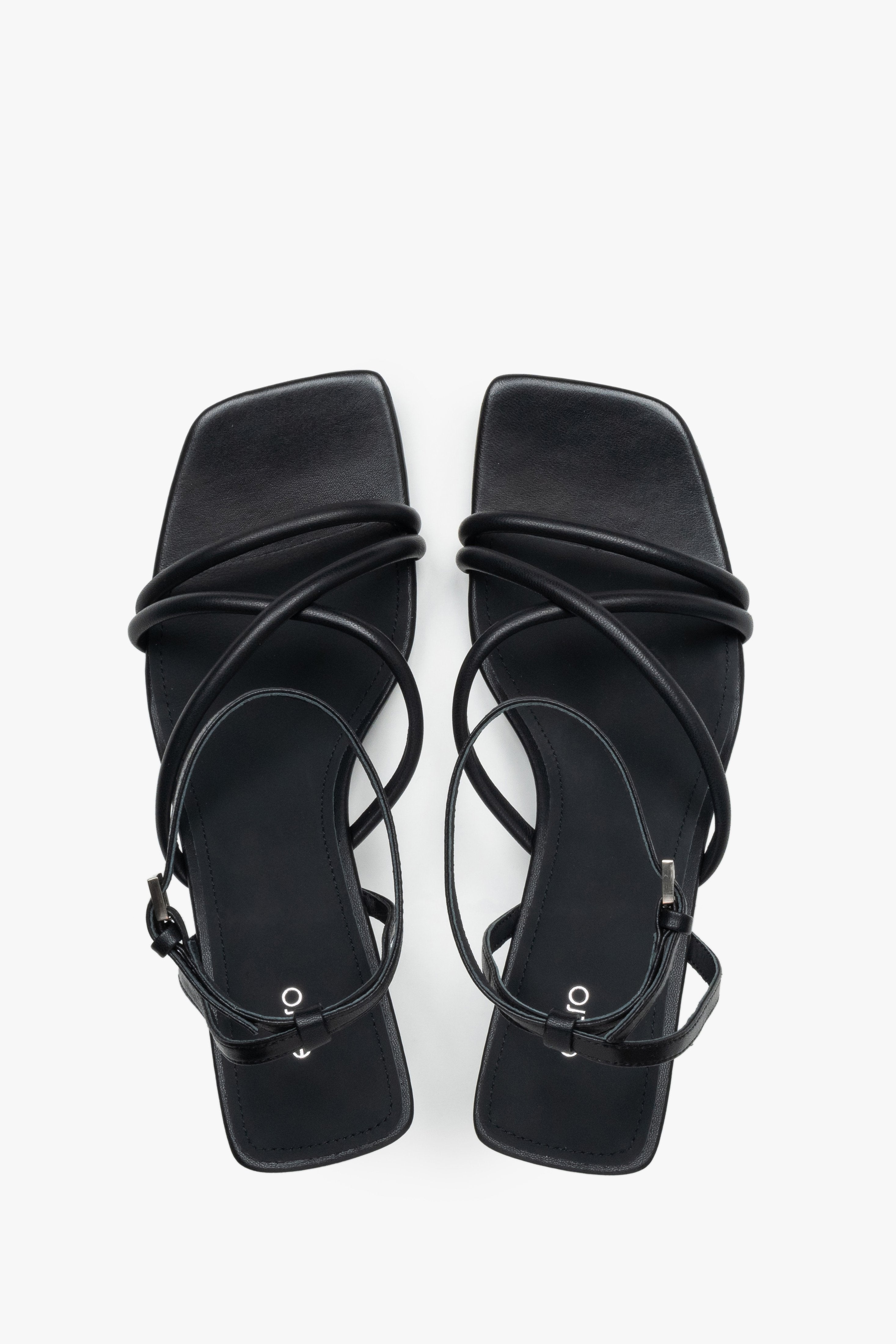 Top view of women’s black leather stiletto sandals with square toe.