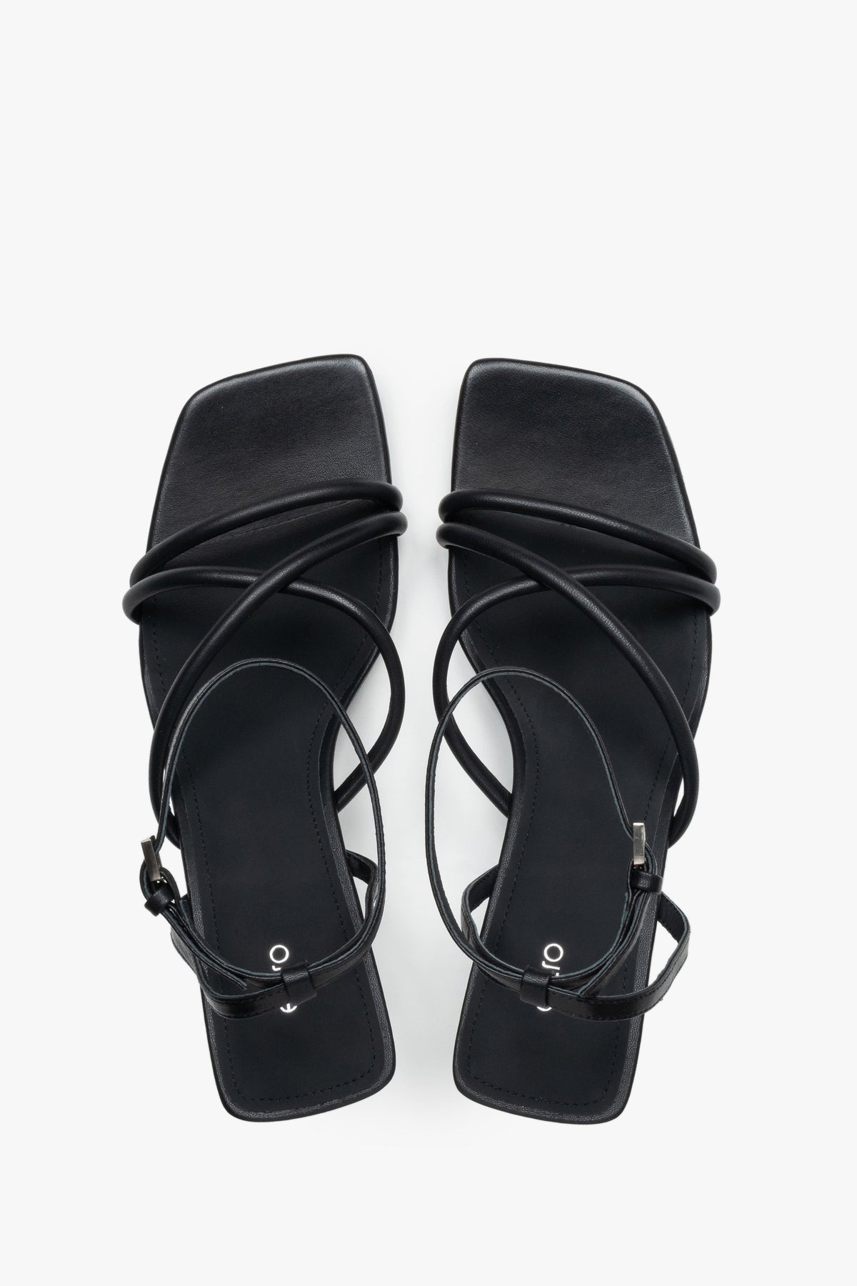 Top view of women’s black leather stiletto sandals with square toe.