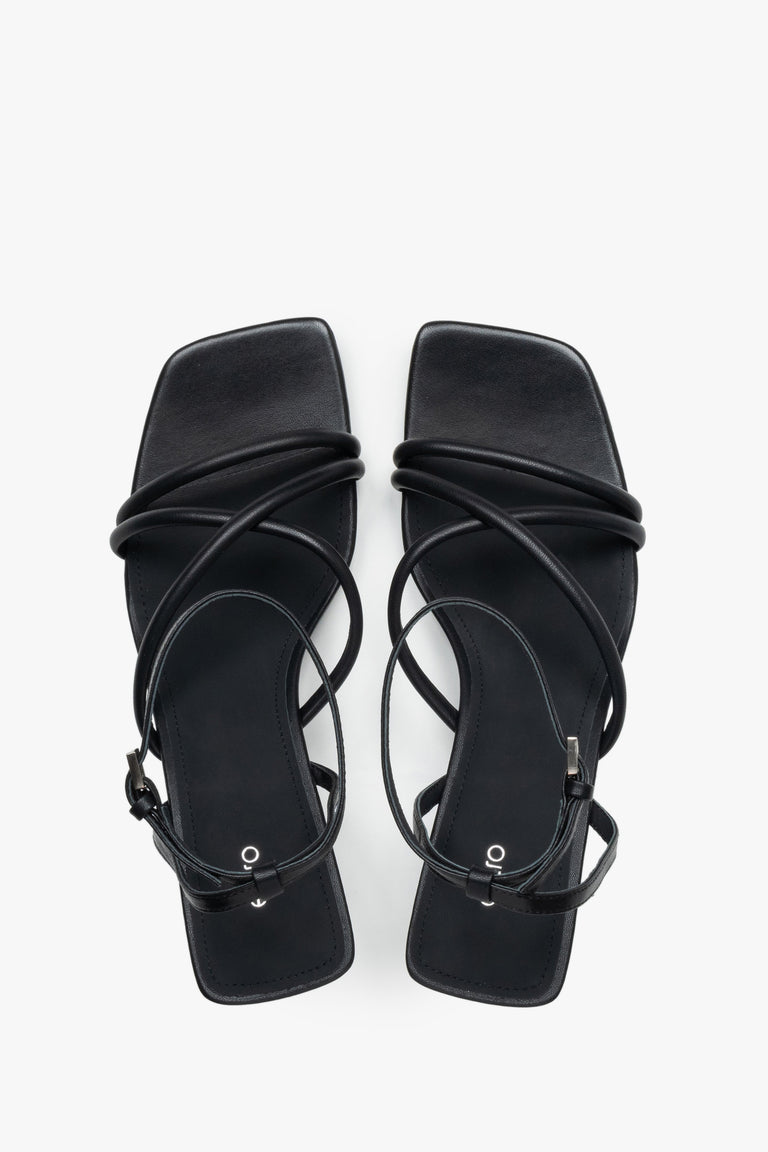 Top view of women’s black leather stiletto sandals with square toe.