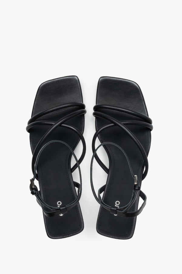 Top view of women’s black leather stiletto sandals with square toe.