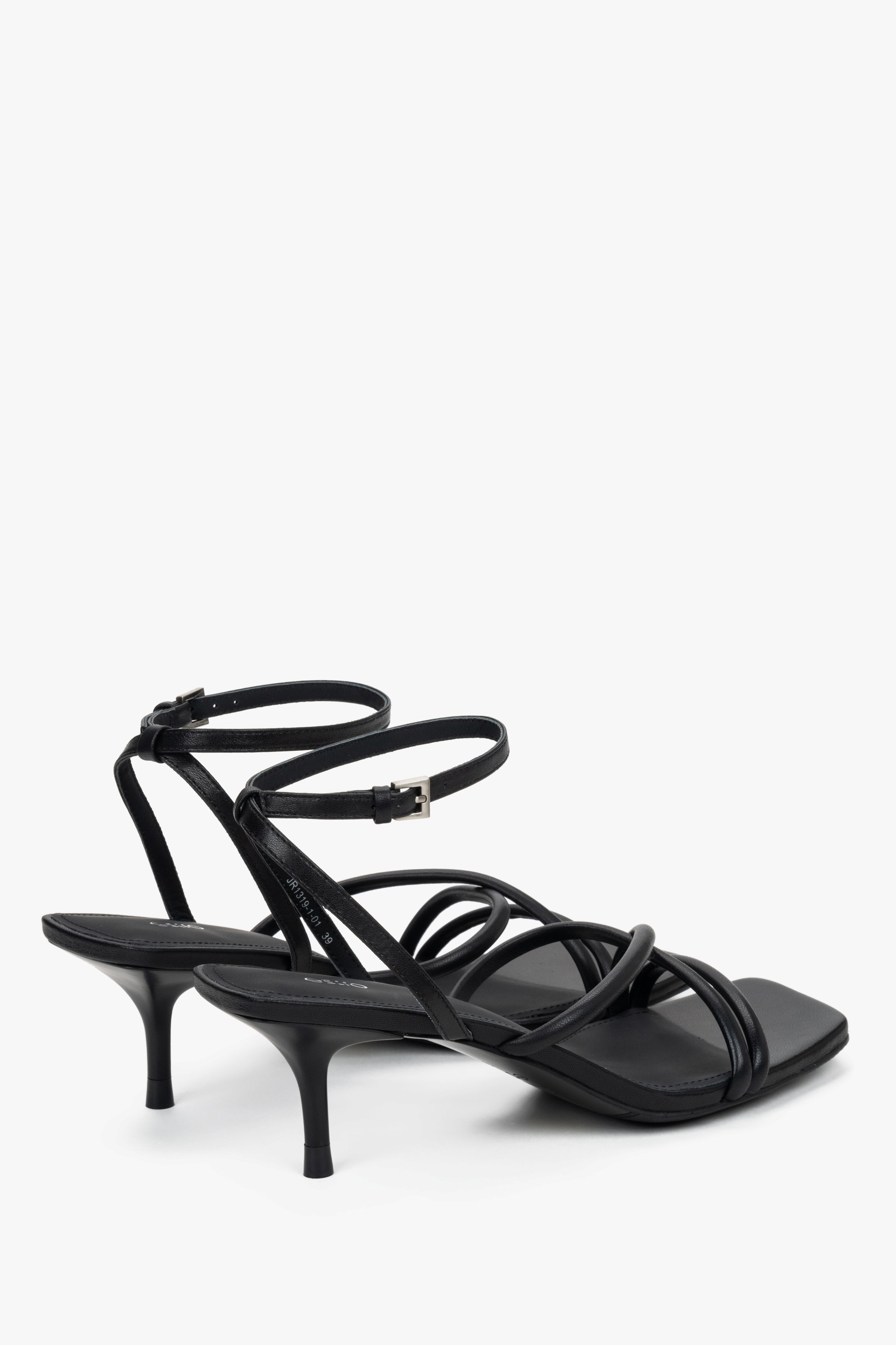 Detail view of soft crossing straps on black leather Estro sandals.