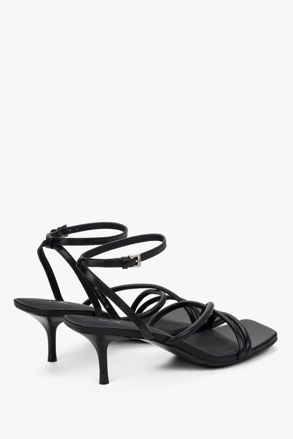 Detail view of soft crossing straps on black leather Estro sandals.