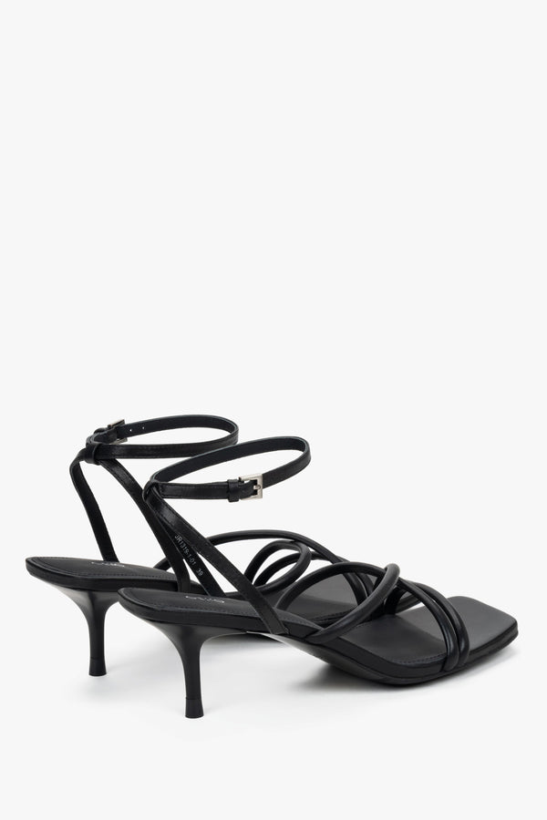 Detail view of soft crossing straps on black leather Estro sandals.