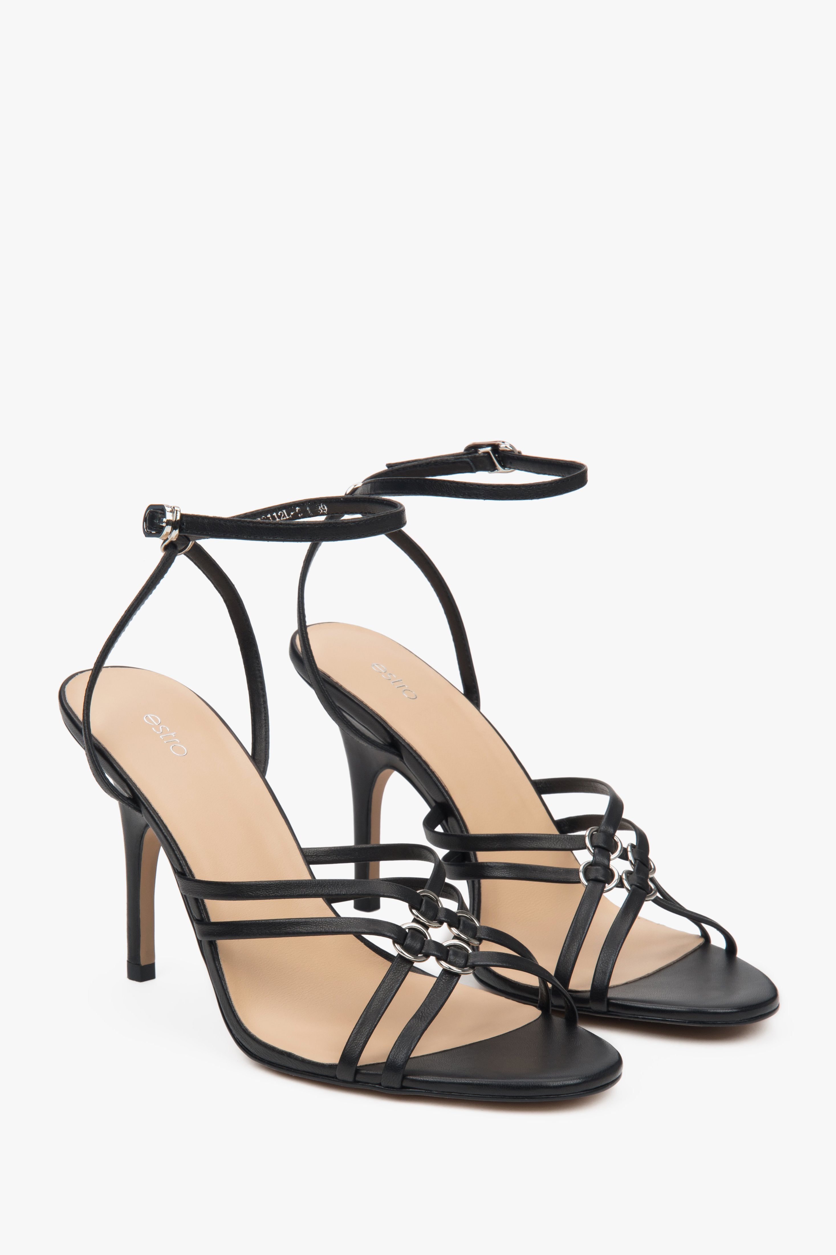 Women’s black leather stiletto sandals with silver details.