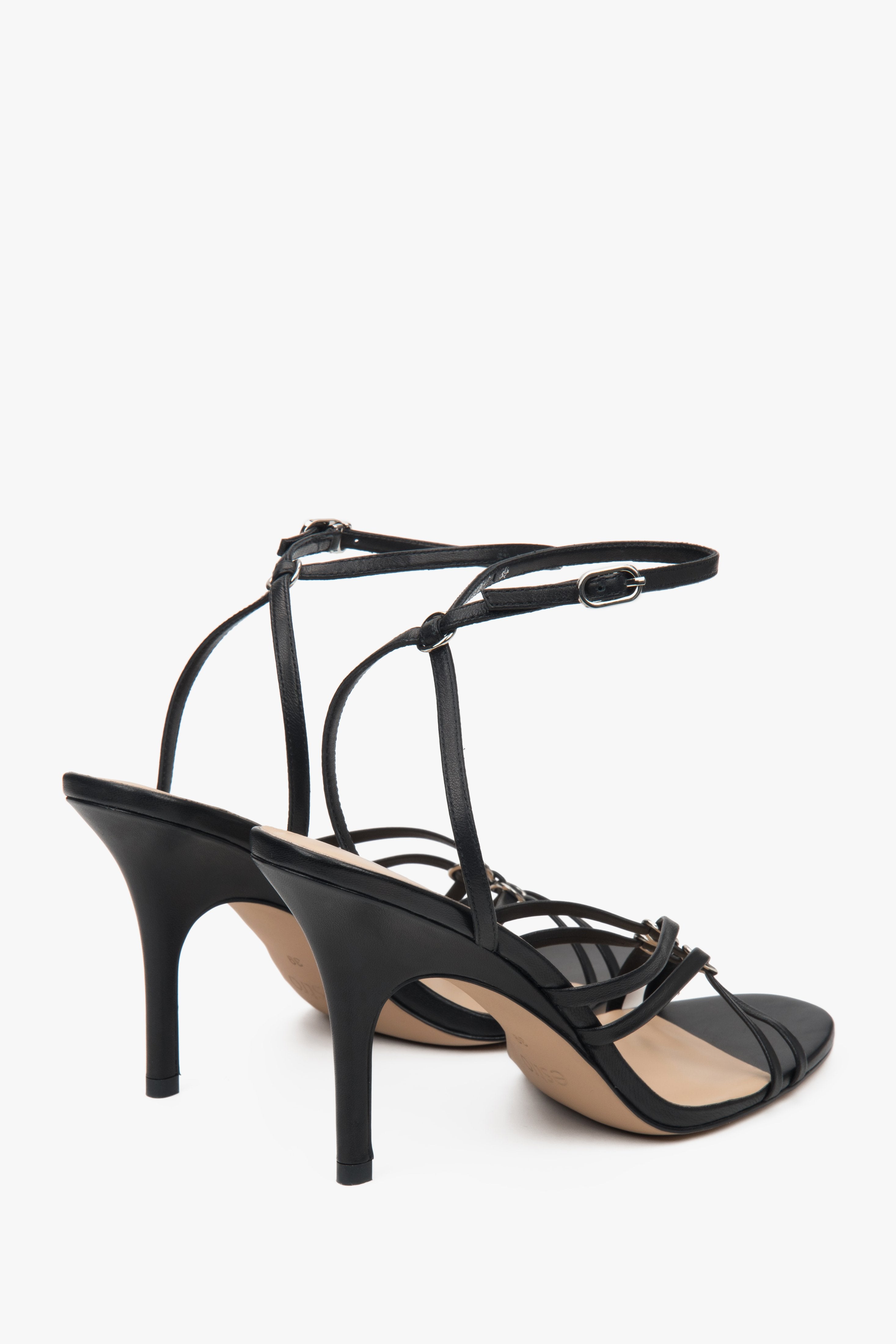 Women’s black leather stiletto sandals with silver details by Estro.