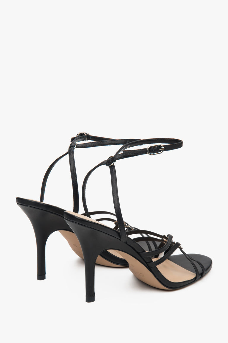 Women’s black leather stiletto sandals with silver details by Estro.