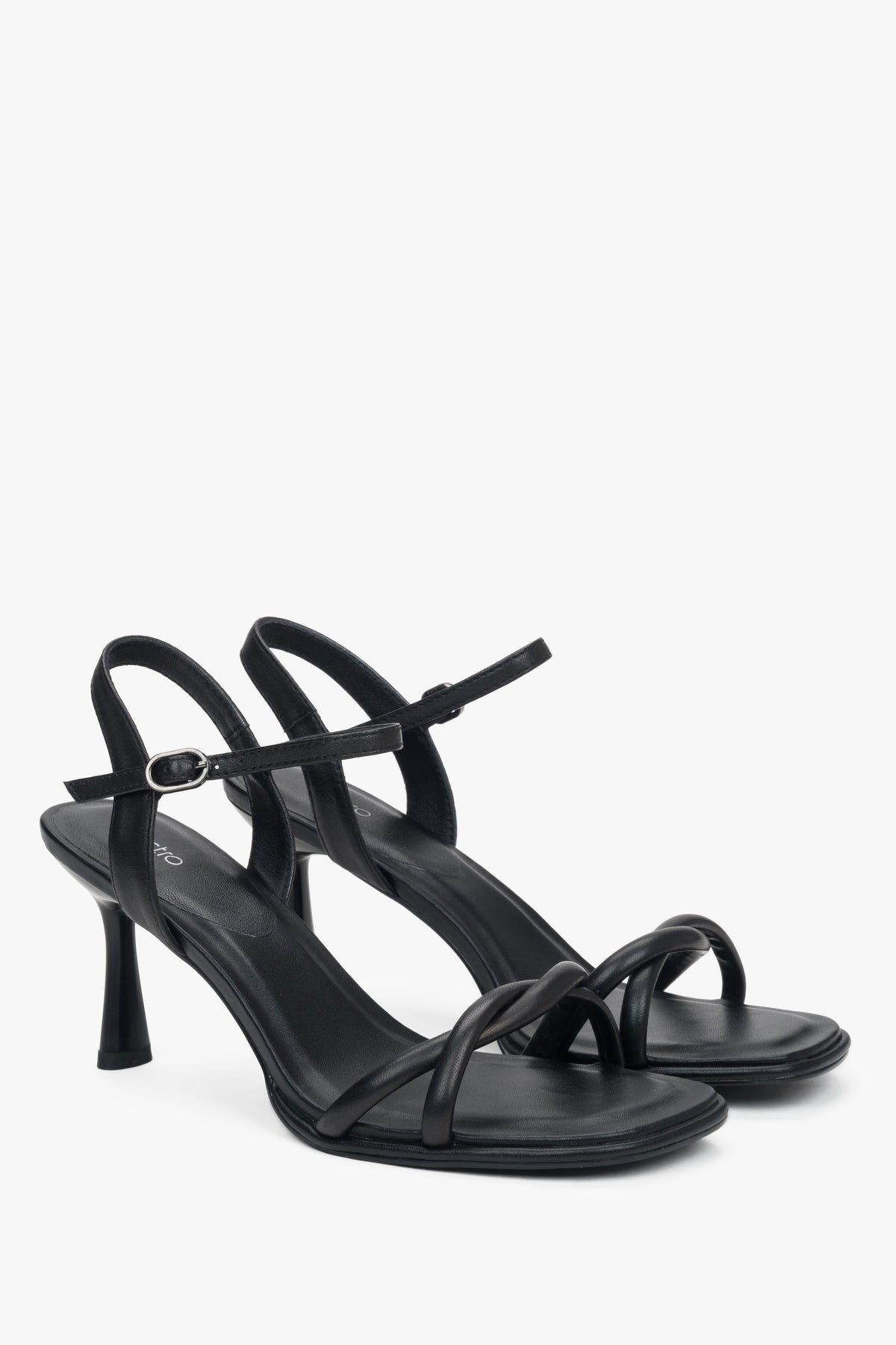 Black women’s leather stiletto sandals with thin straps.
