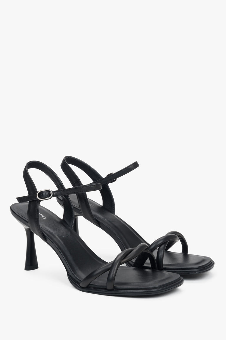 Black women’s leather stiletto sandals with thin straps.