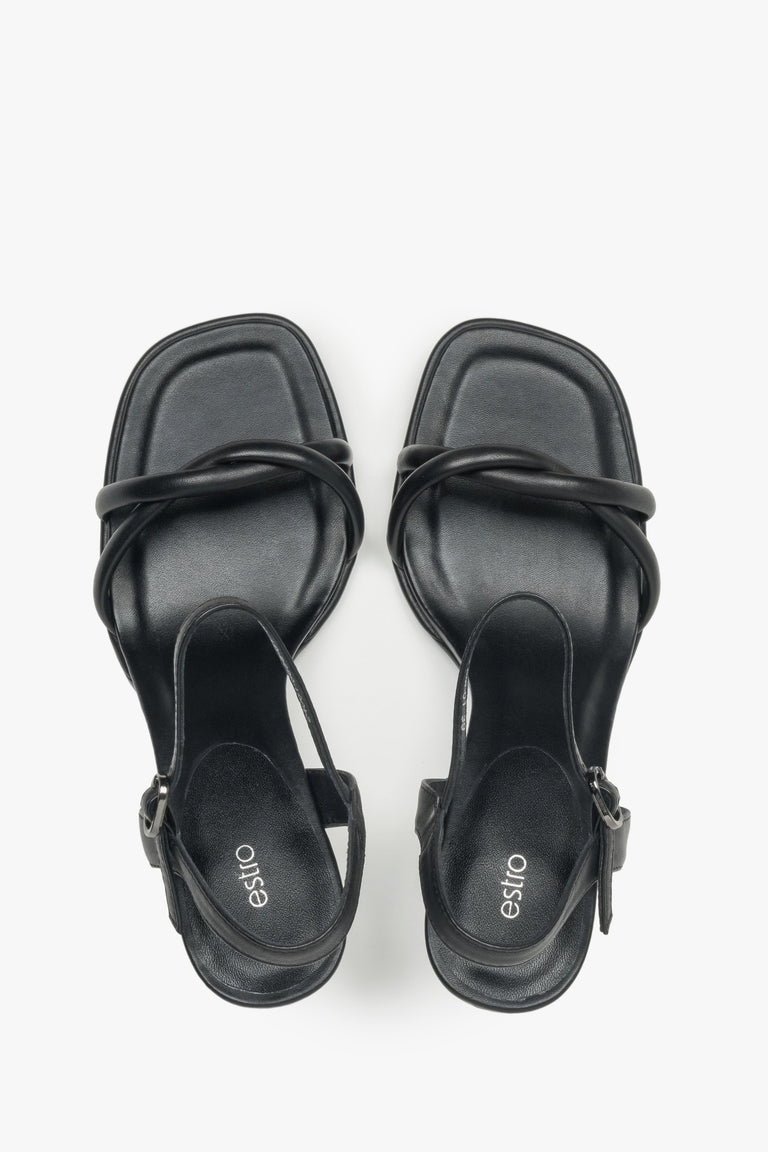 With a stiletto heel, black women’s leather sandals with thin straps by Estro.