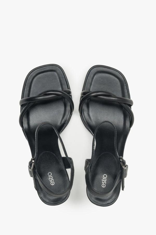 With a stiletto heel, black women’s leather sandals with thin straps by Estro.