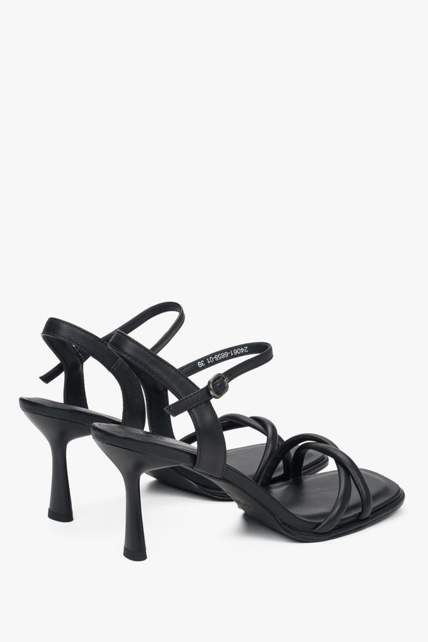 With thin straps, black women’s leather stiletto sandals by Estro.