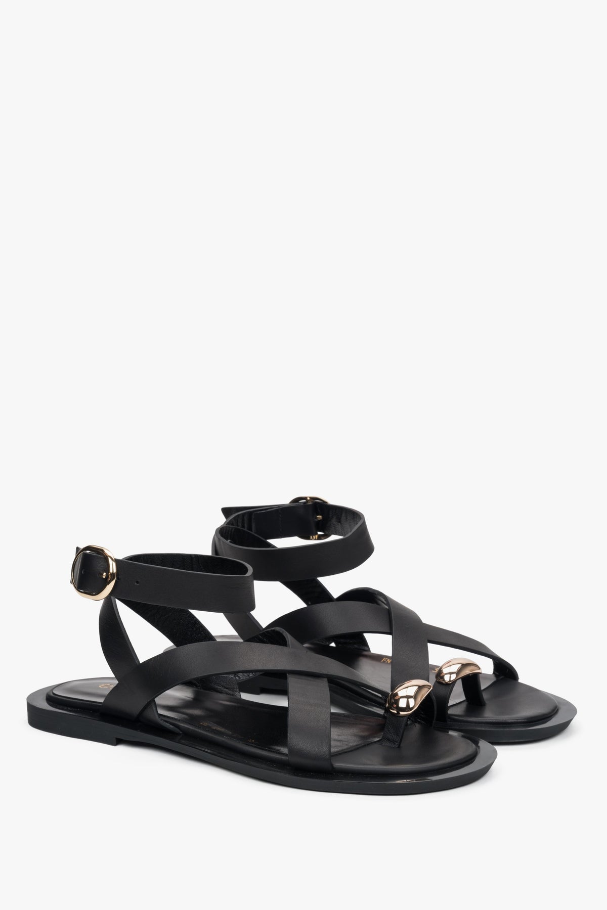 Elegant black leather strappy sandals from Estro, featuring a minimalist design with a chic toe ring detail. 