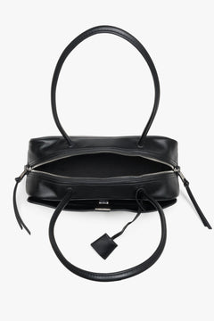 Black women’s shoulder bag in genuine leather with decorative zipper charms.