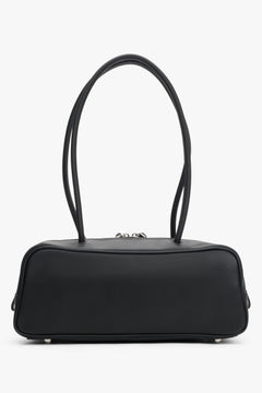 Compact structured shoulder bag in genuine leather with textile lining and tassel details.