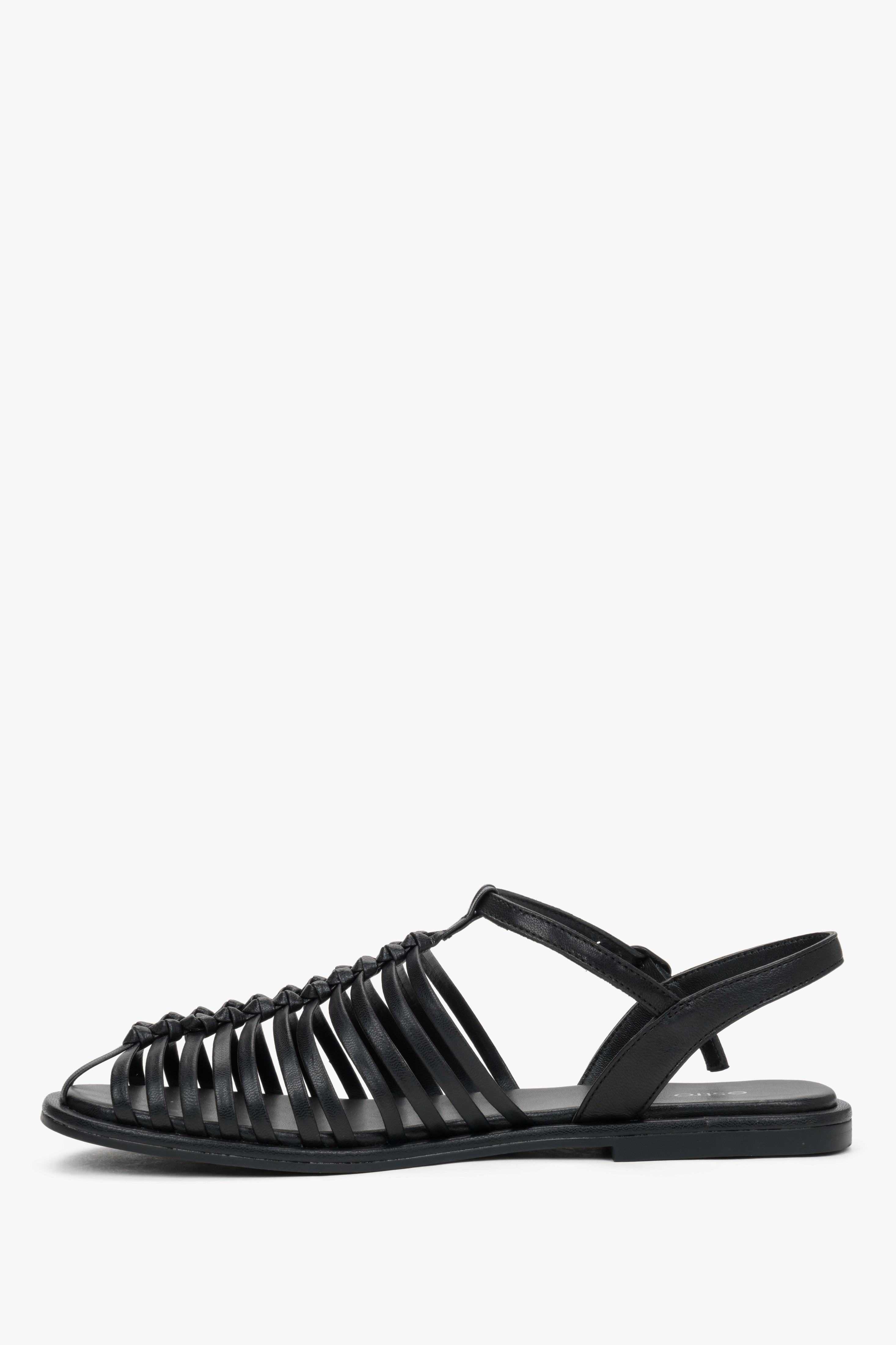 Elegant black genuine leather closed-toe sandals with a flat heel.