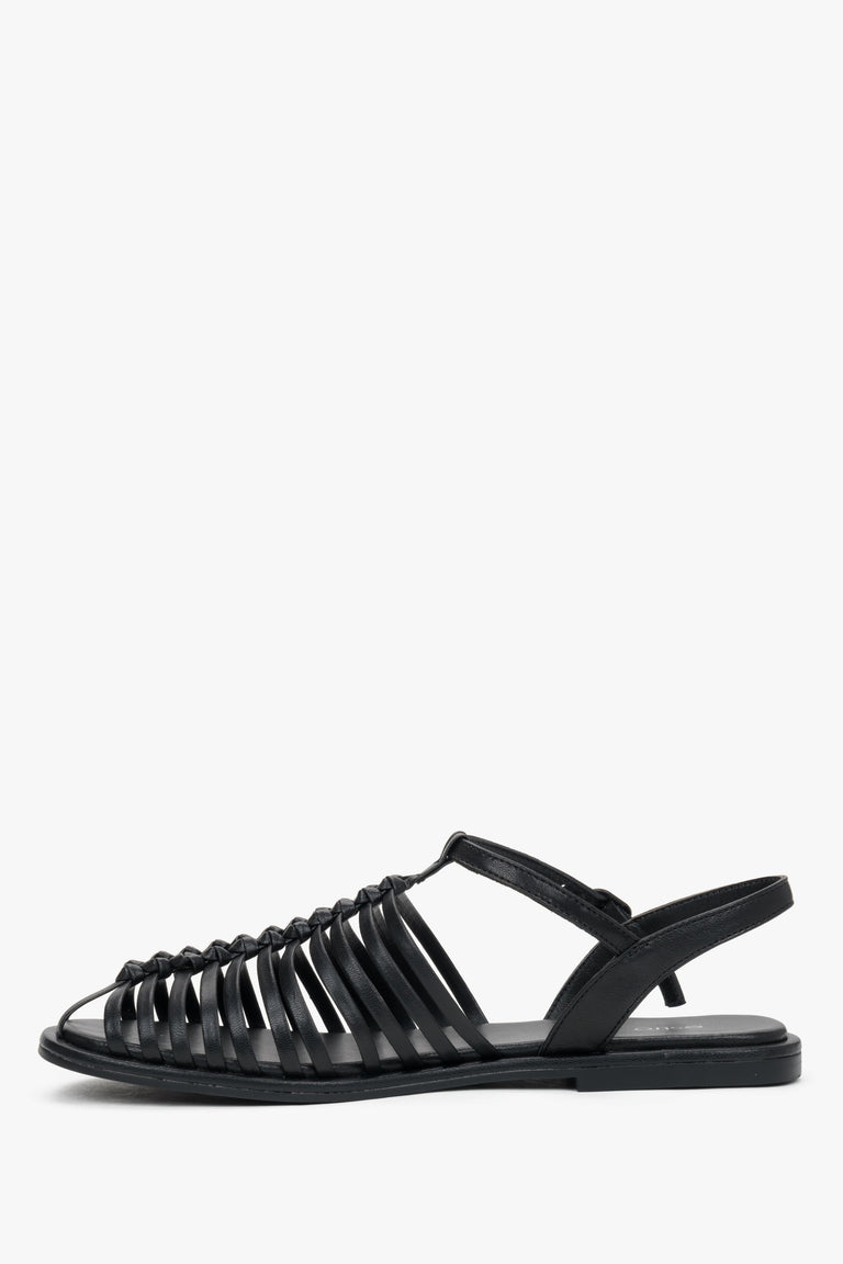 Elegant black genuine leather closed-toe sandals with a flat heel.