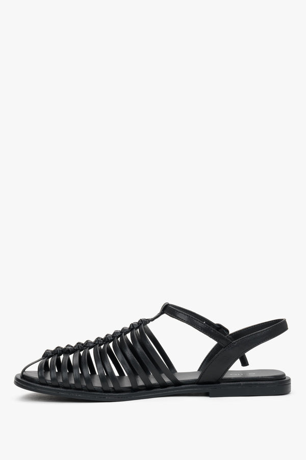 Elegant black genuine leather closed-toe sandals with a flat heel.