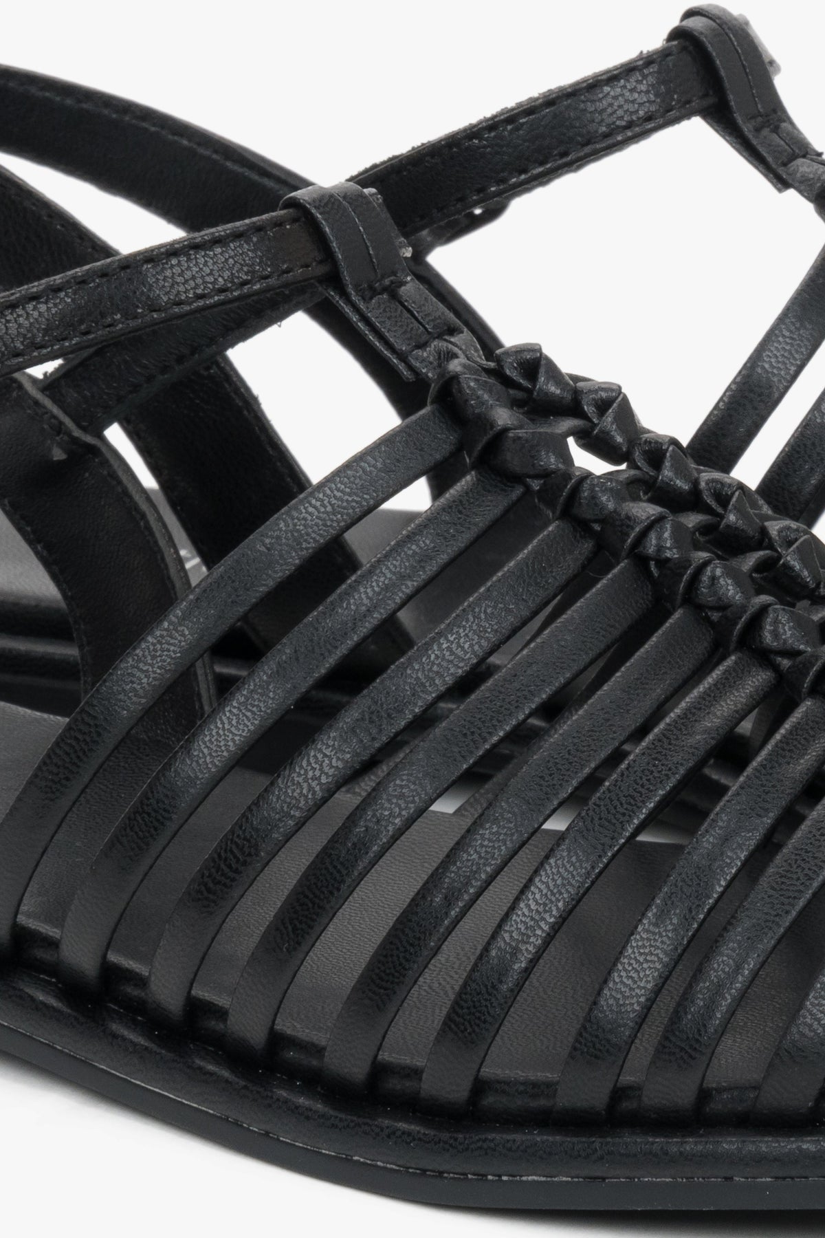 Flat black summer sandals with thin leather straps and buckle closure.
