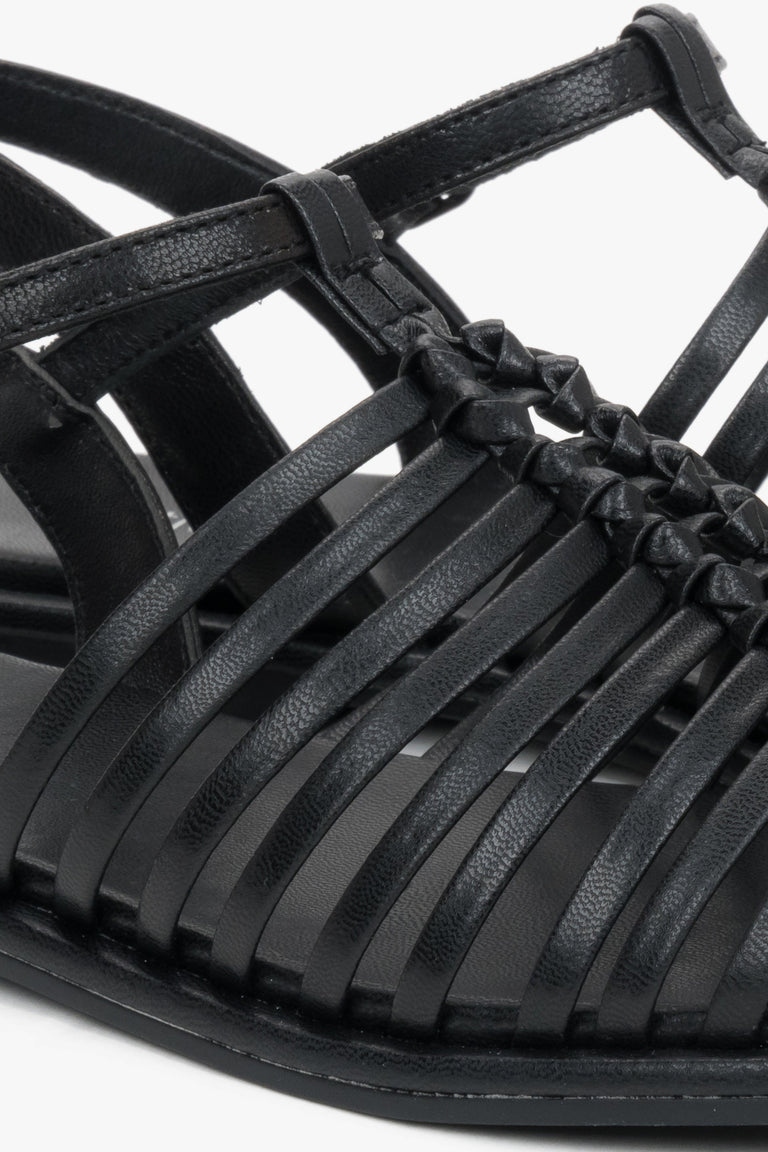 Flat black summer sandals with thin leather straps and buckle closure.