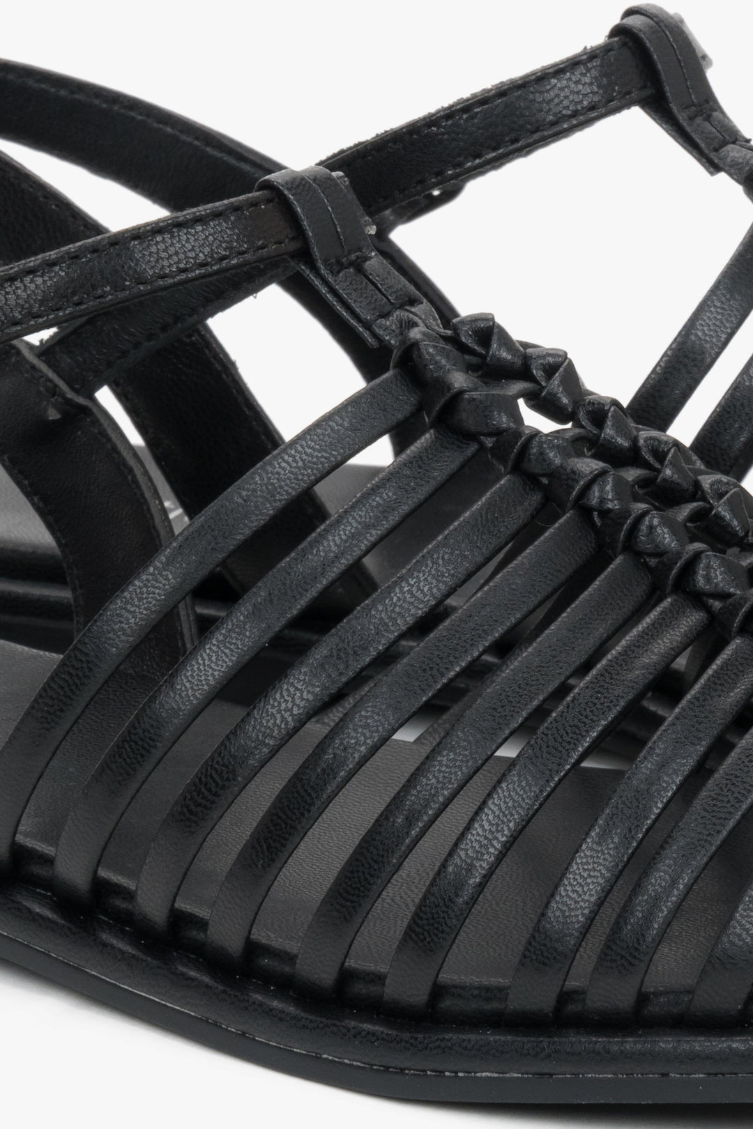Flat black summer sandals with thin leather straps and buckle closure.
