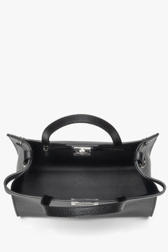 Secure buckle closure with brand logo, plus interior compartments to keep essentials organized.