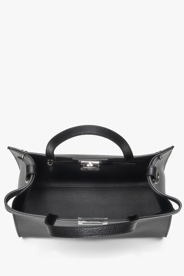 Secure buckle closure with brand logo, plus interior compartments to keep essentials organized.