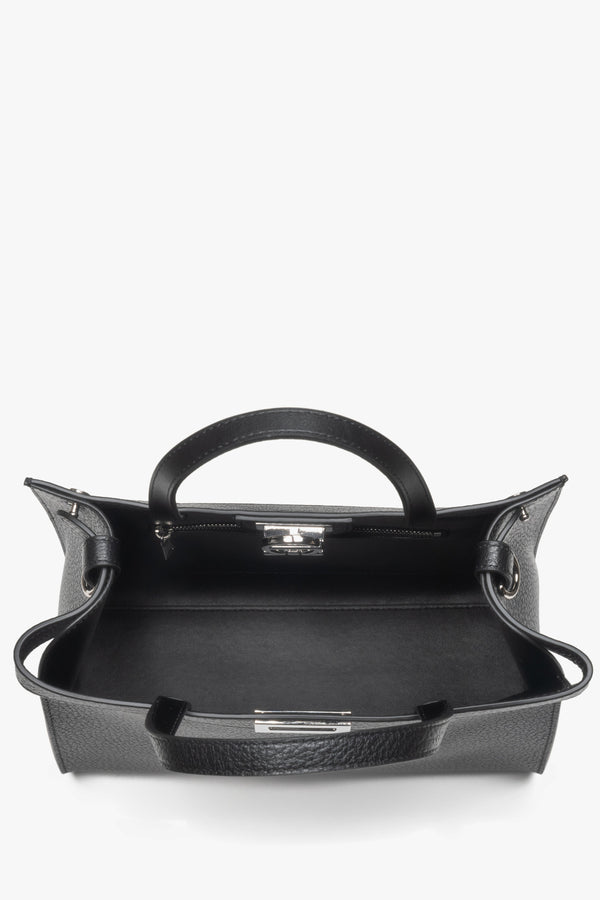 Secure buckle closure with brand logo, plus interior compartments to keep essentials organized.