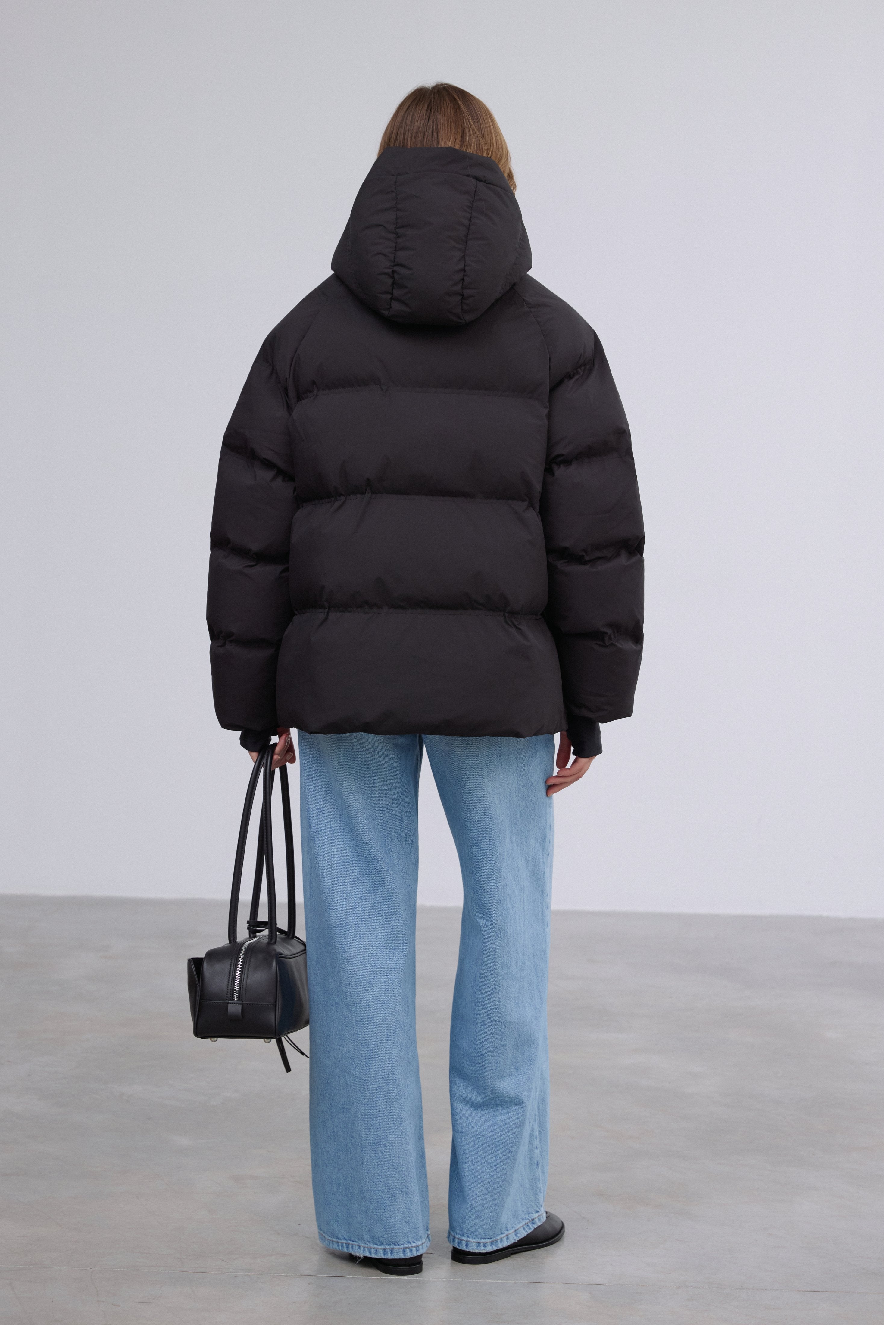 Front view showcasing the relaxed loose-fit silhouette in timeless black.