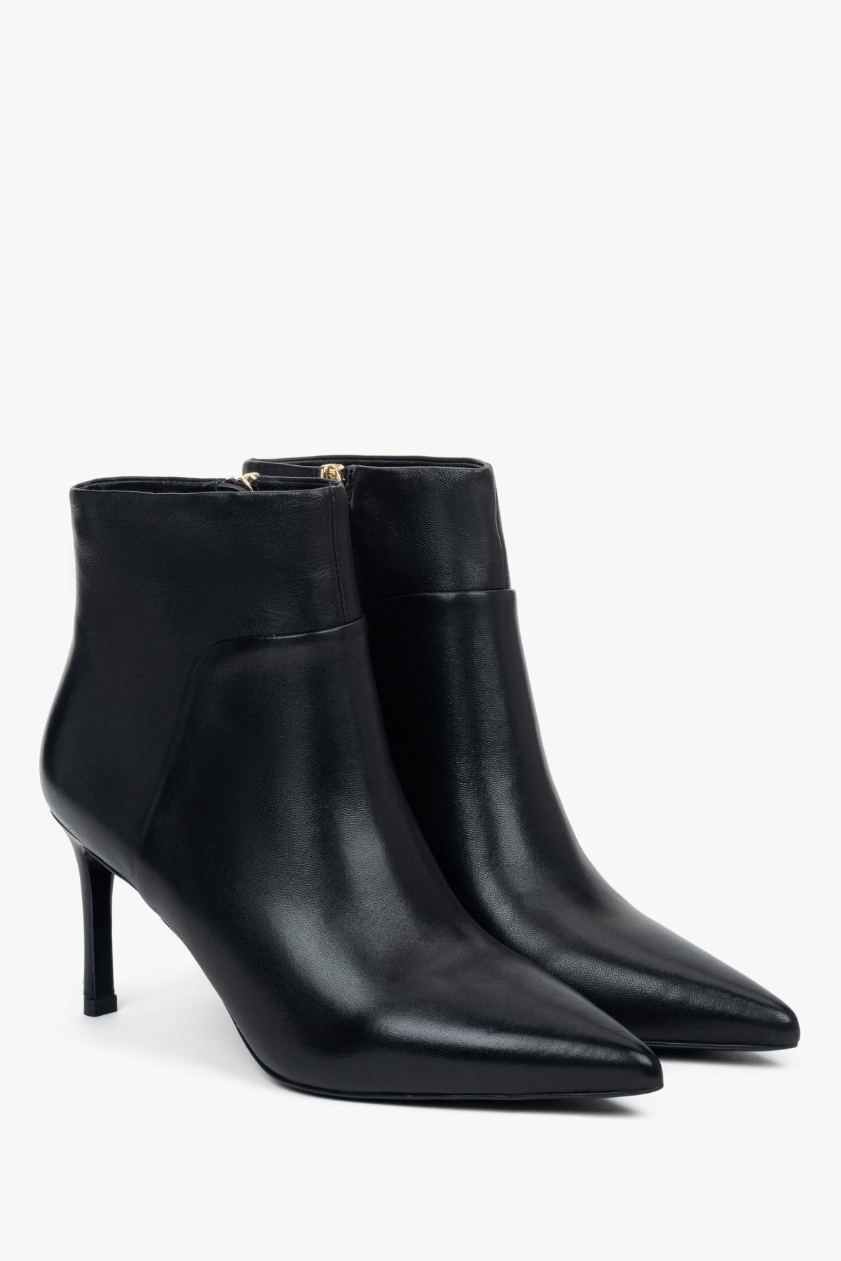 Black, low women’s ankle boots with a pointed toe on a stiletto heel.

