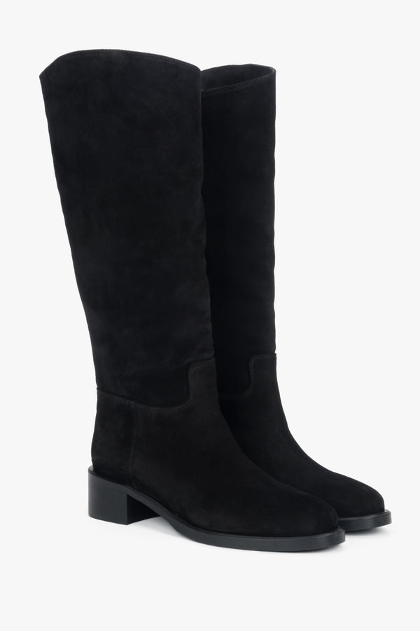 On a low heel, black women’s knee-high boots made of natural velour Estro.
